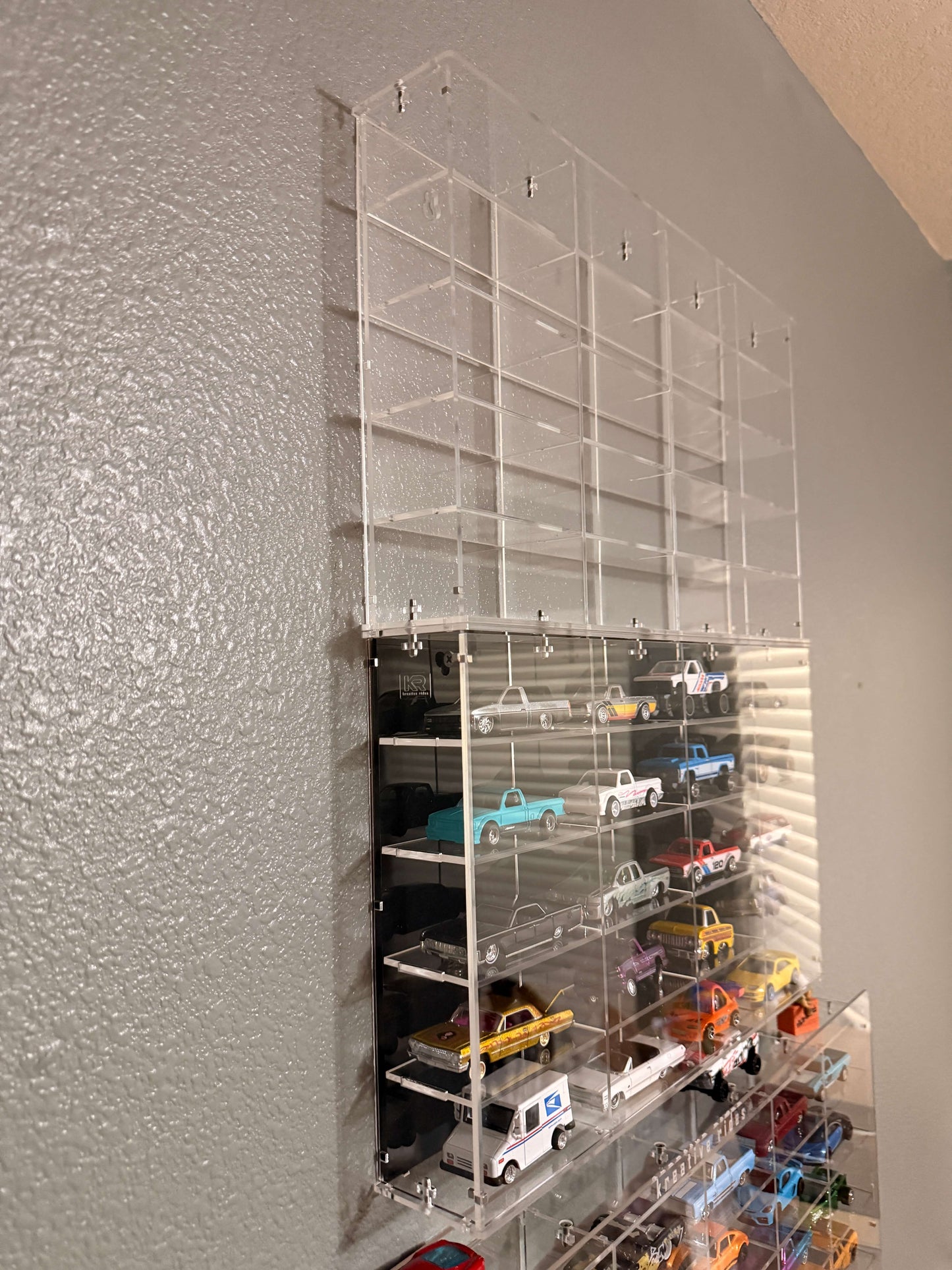 THE TWENTY PACK - Acrylic display case with a clear or black background that holds up to 20 individual 1:64 scale model vehicles