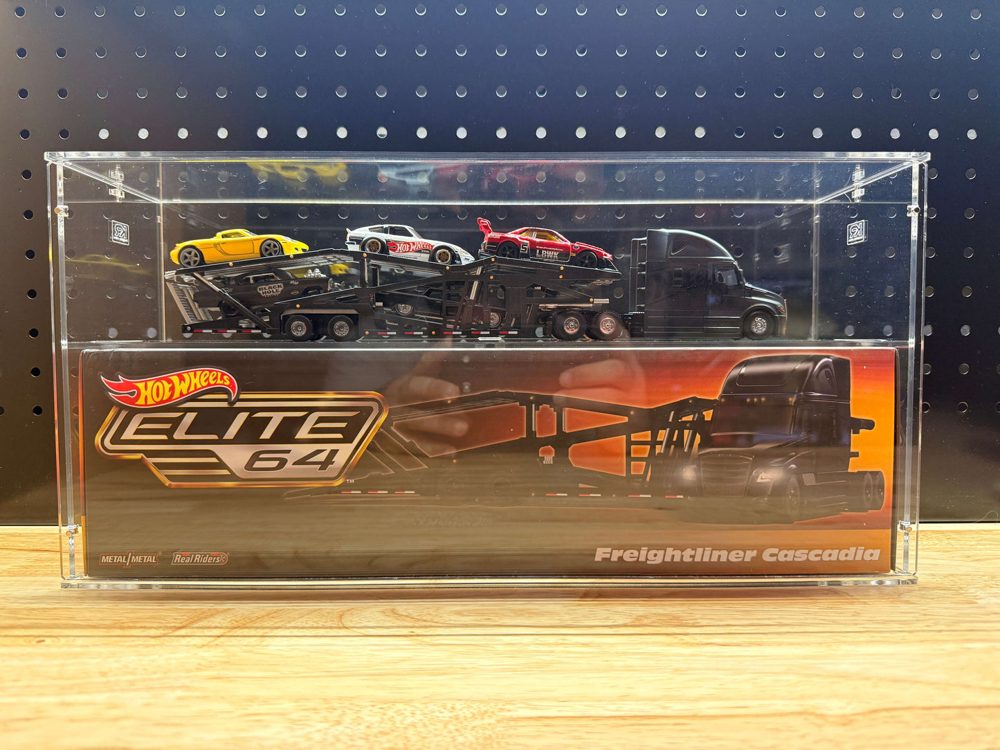 Hot Wheels Elite 64 Freightliner Cascadia in an acrylic display case
