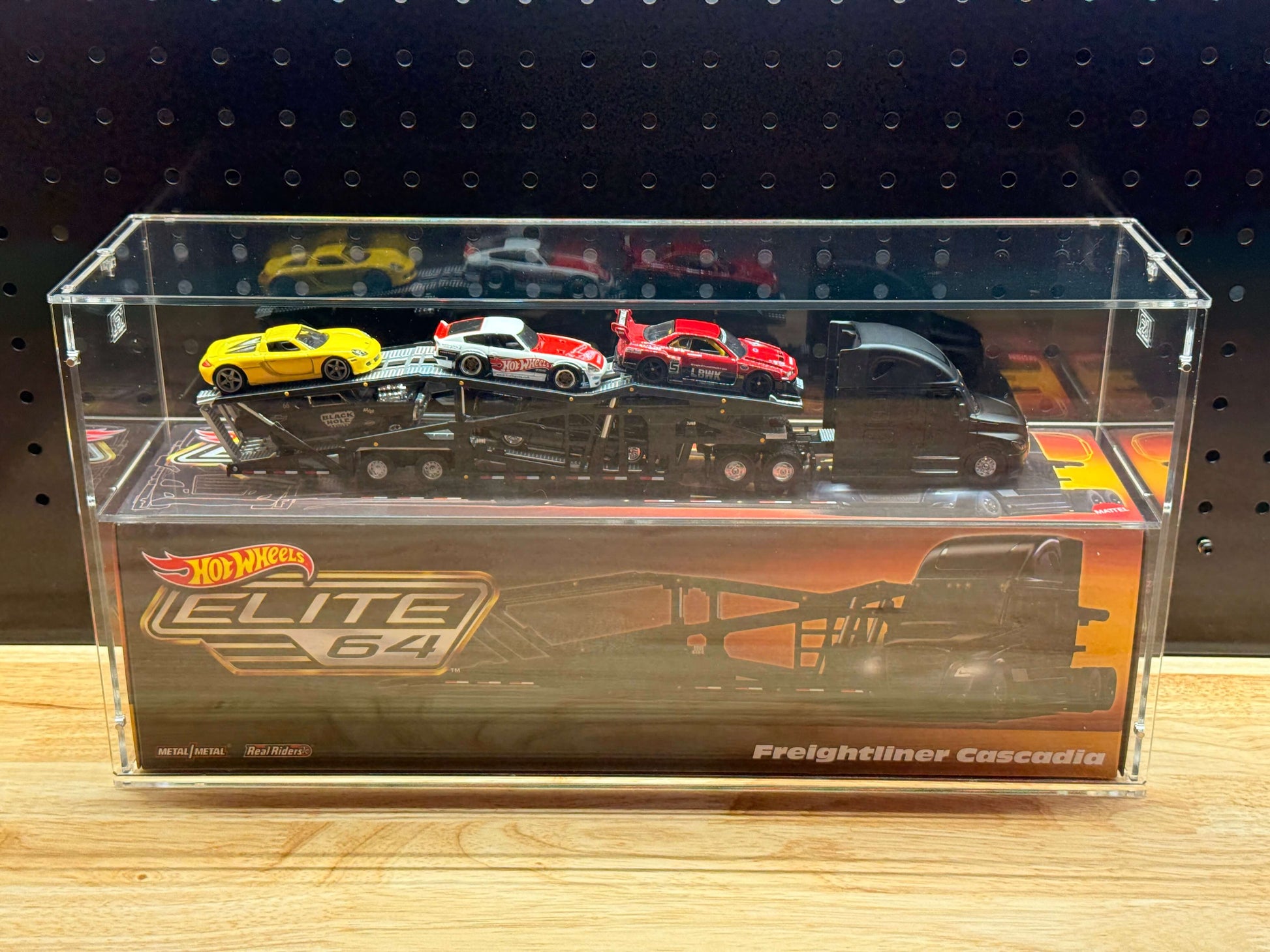 Hot Wheels Elite 64 Freightliner Cascadia in an acrylic display case